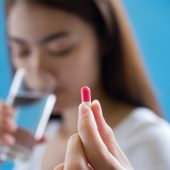 woman hand holding a pills take medicine according to the doctor's order